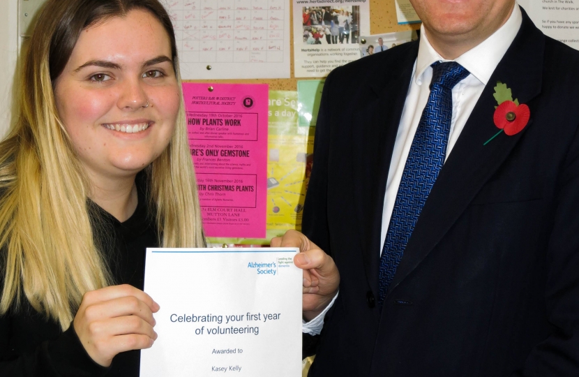 Oliver Dowden MP presenting award to an Alzheimer's Society Volunteer