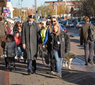 Oliver Dowden MP walking Shenley Road, Borehamwood, during a sight loss simulation event.