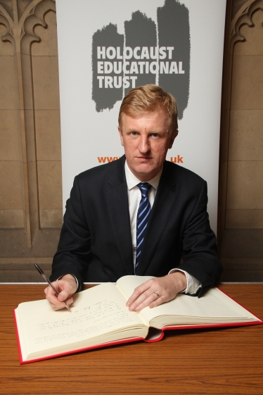 Oliver Dowden MP signing the Holocoaut Memorial Day Book of Committment