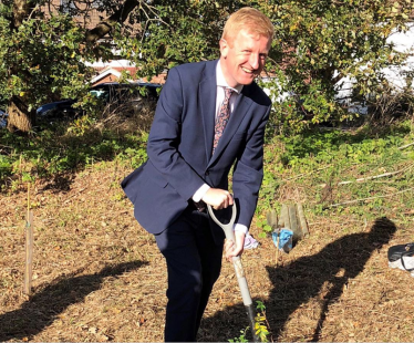 Oliver planting a tree