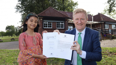 Mr Dowden presenting Moksha Roy with the Points of Light Award.