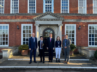 Oliver with Executive Principal, Gus Lock, COO, Robb Dunn and students