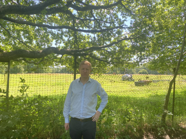 Sir Oliver Dowden MP in front of Horses’ Field off Barnet Lane
