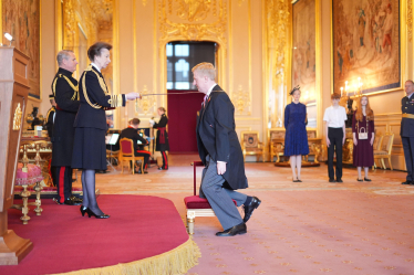 Sir Oliver receiving the Knight Commander of the Order of the Bath, presented by Her Royal Highness, Princess Anne, The Princess Royal at the Investiture